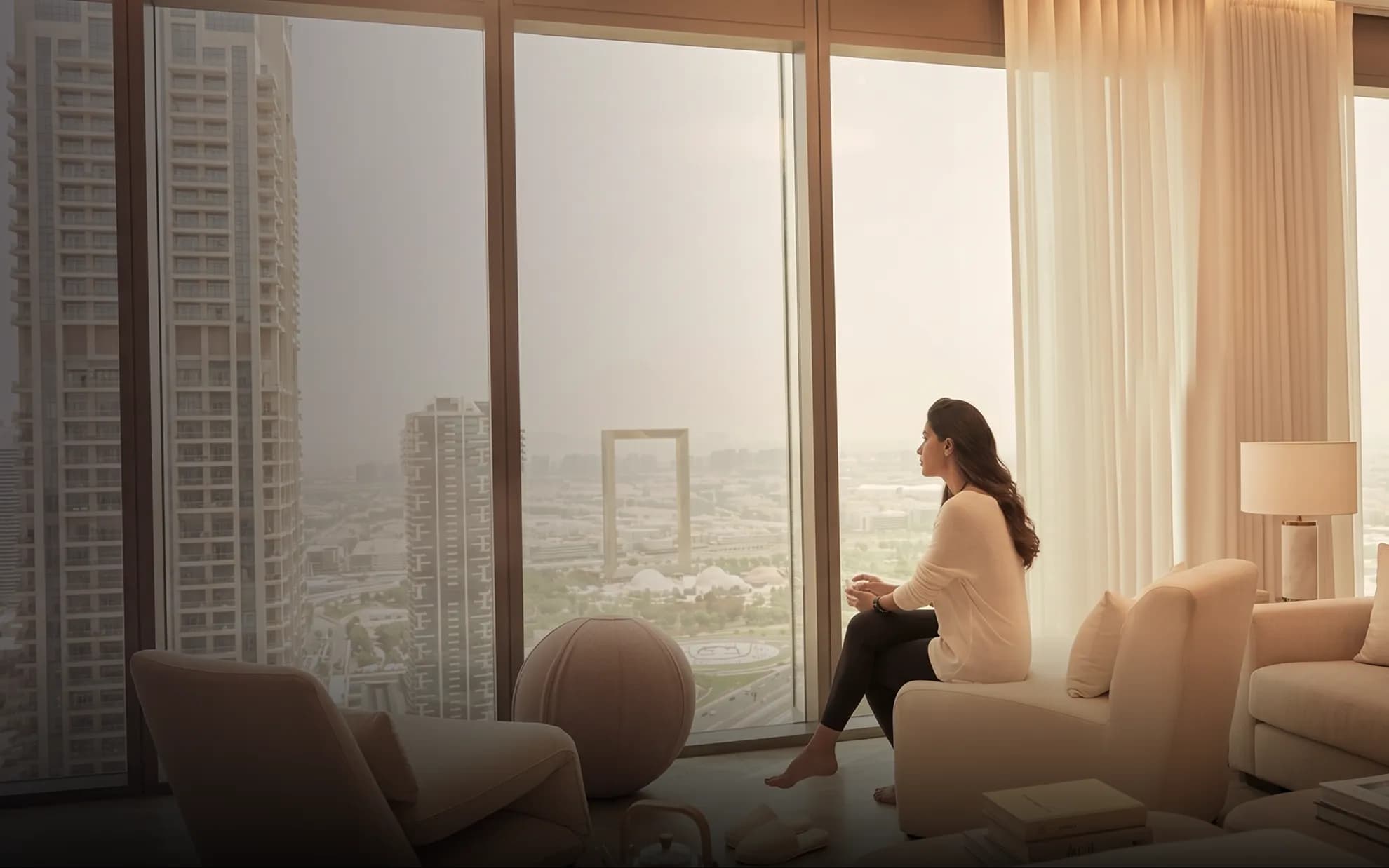 Woman looking out of apartment window